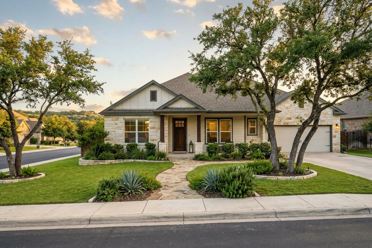 Charming single-story ranch home in suburban Austin Texas neighborhood with live oak trees and Hill Country landscape