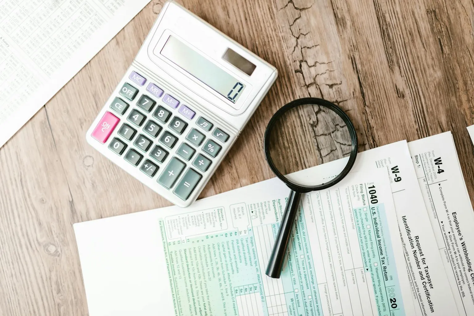 Real estate documents and calculator on a desk representing 1031 exchange tax planning
