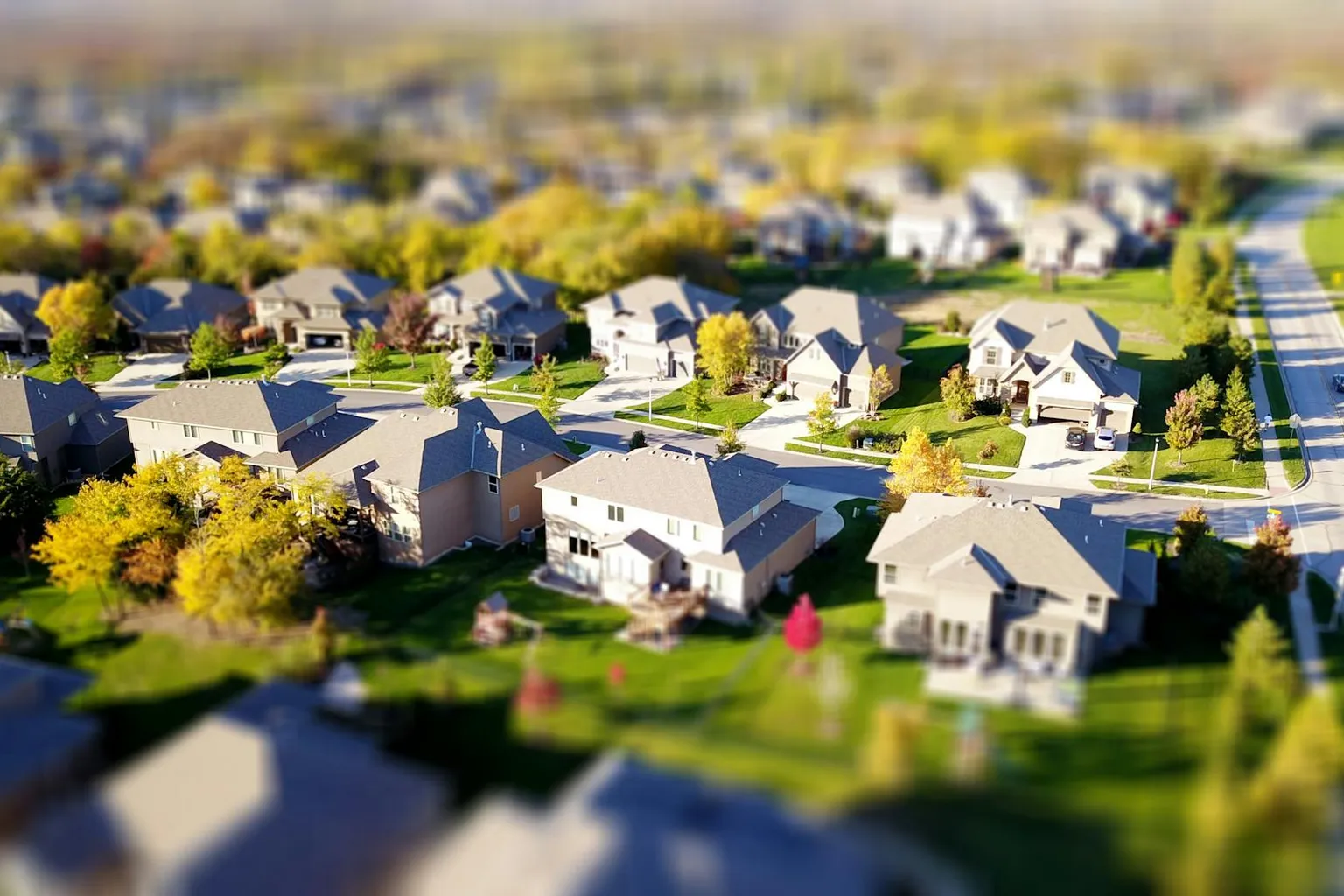 Aerial view of a suburban neighborhood with homes and tree-lined streets