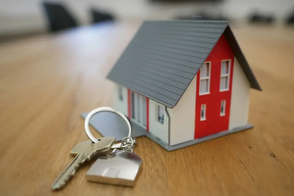 House model with calculator and financial documents on desk representing home equity