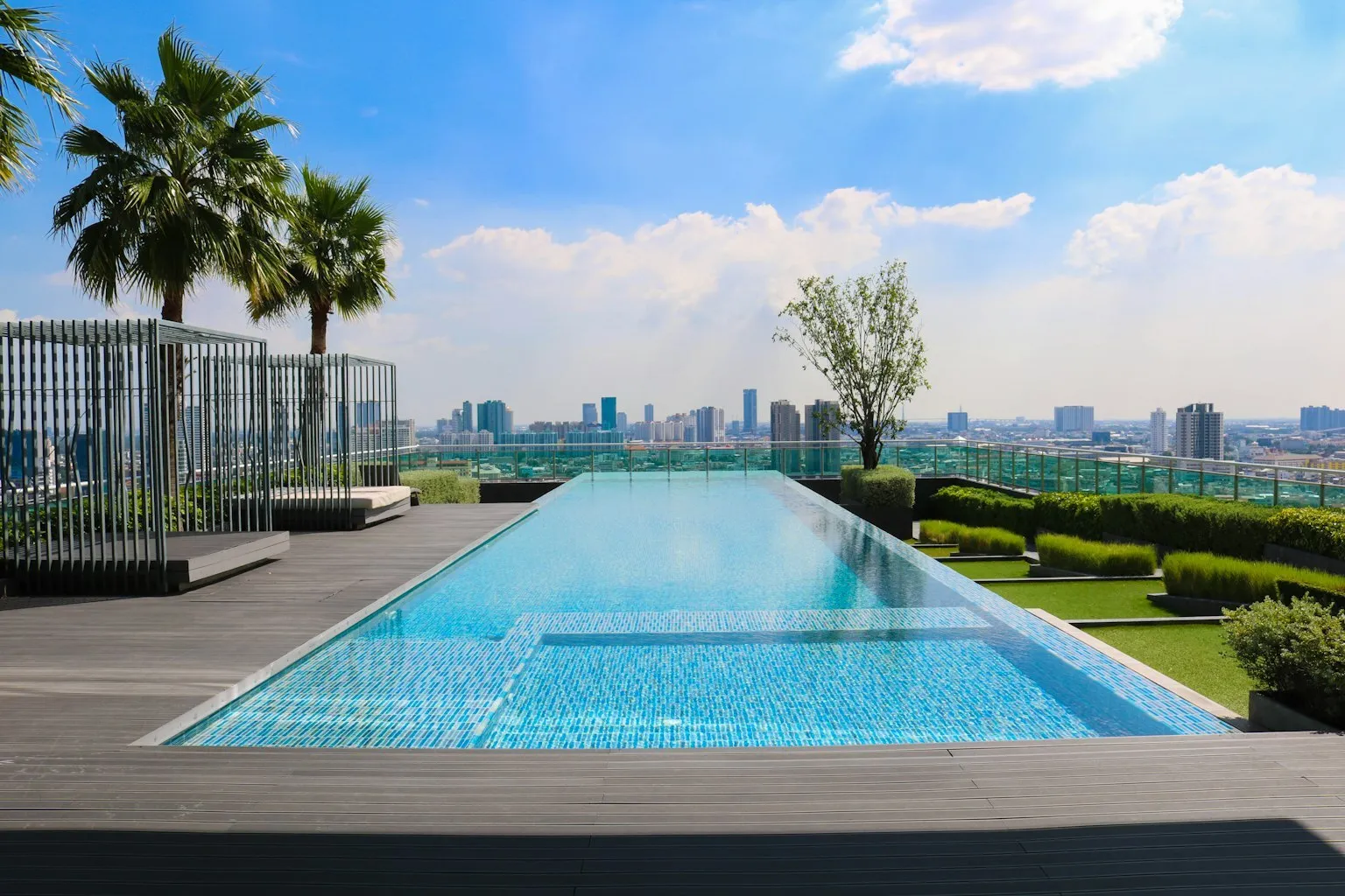 Community swimming pool with lounge chairs at an HOA amenity center