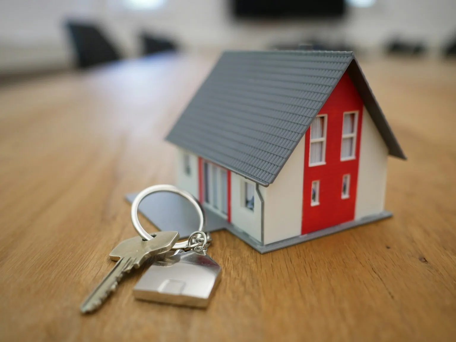 House keys next to a model home representing the homebuying decision