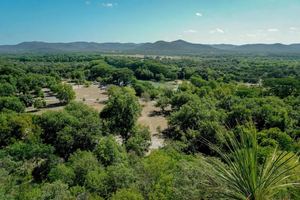 Aerial view of lush green valley and hills in the Texas Hill Country