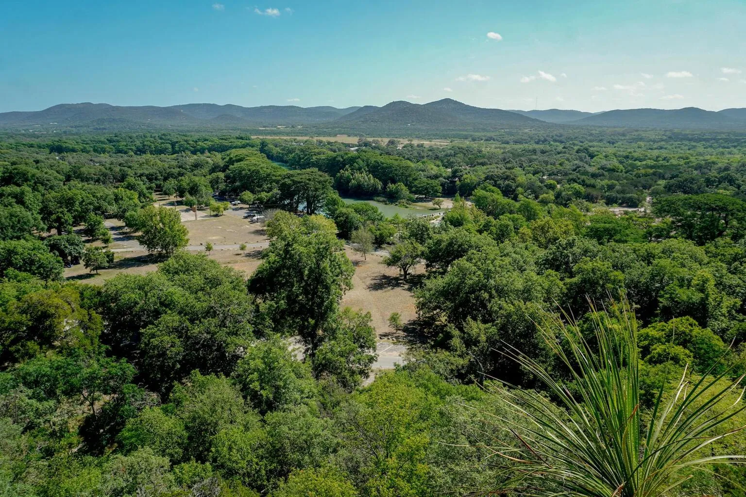 Aerial view of lush green valley and hills in the Texas Hill Country