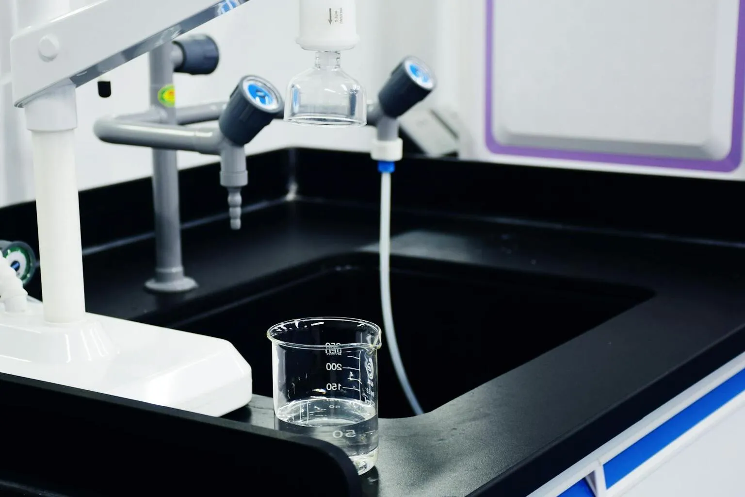 Laboratory water quality testing equipment with beakers and filtration system