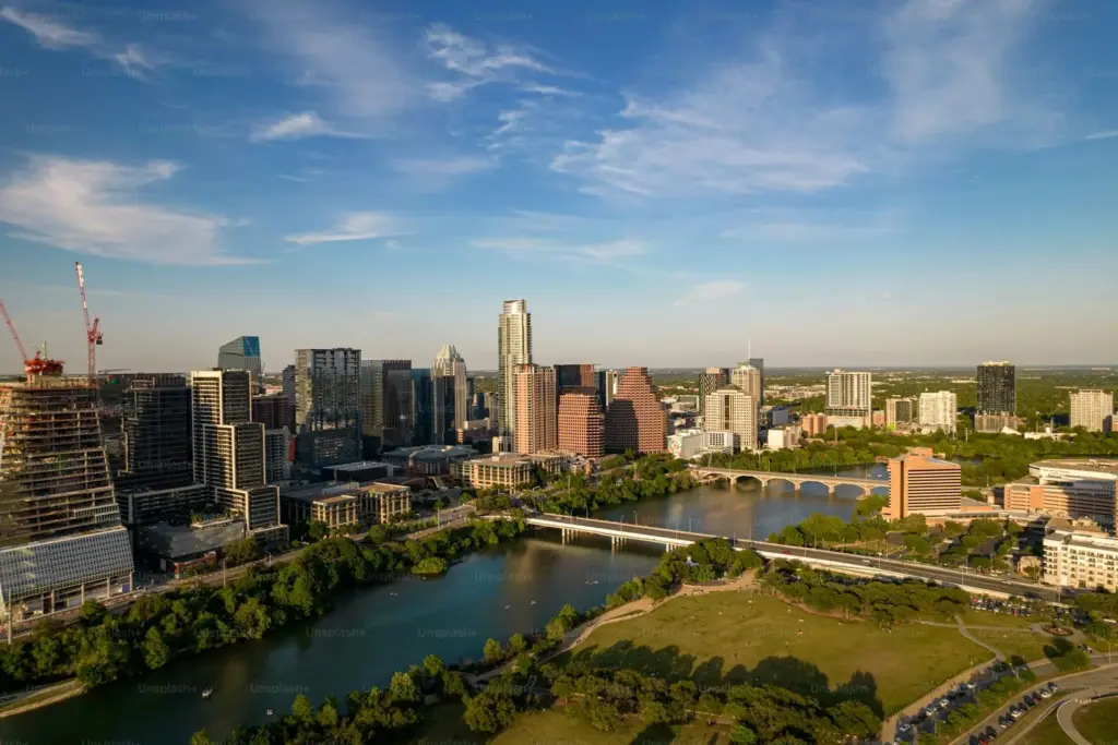 Aerial view of downtown Austin Texas skyline with Lady Bird Lake and Congress Avenue Bridge at golden hour