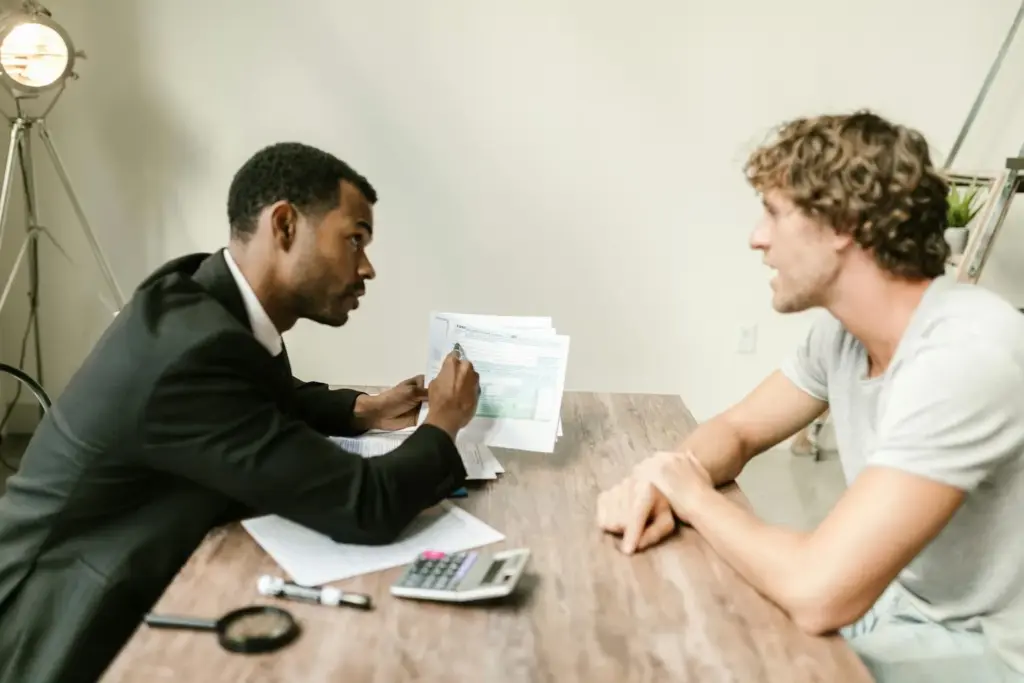 Mortgage lender consultation with client reviewing loan documents