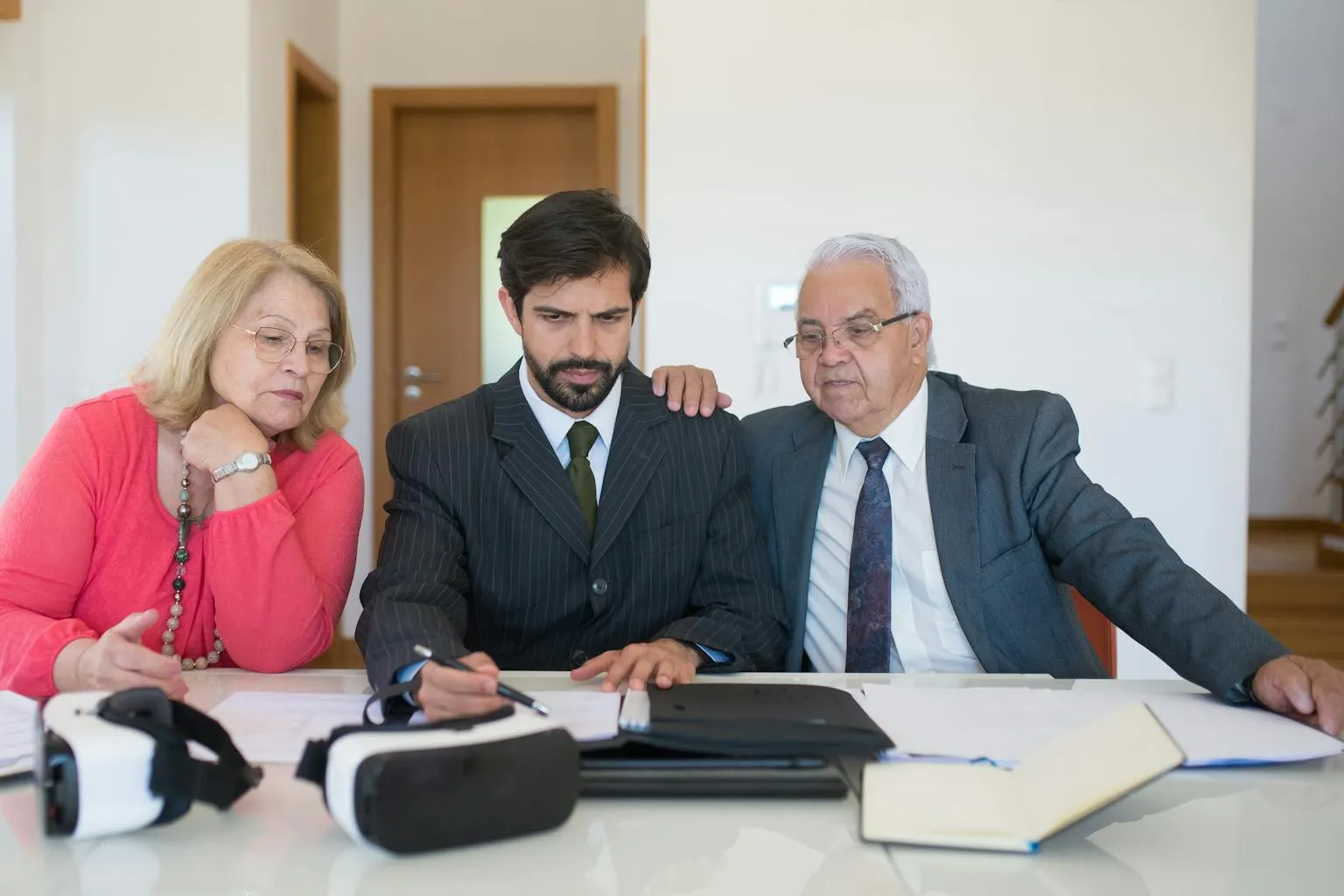 Real estate agent reviewing documents with clients during a professional consultation