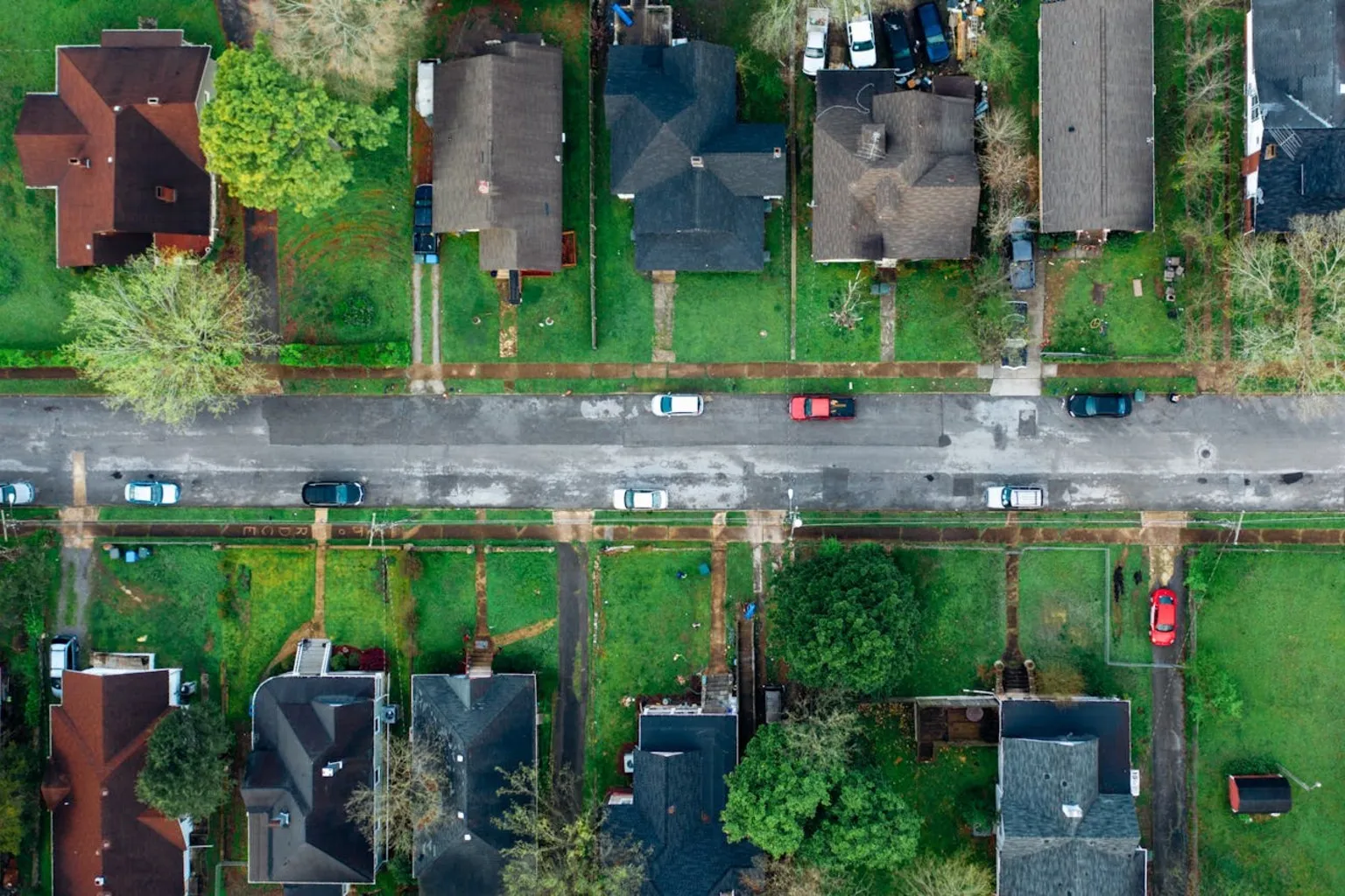 Aerial view of suburban neighborhood with homes and tree-lined streets