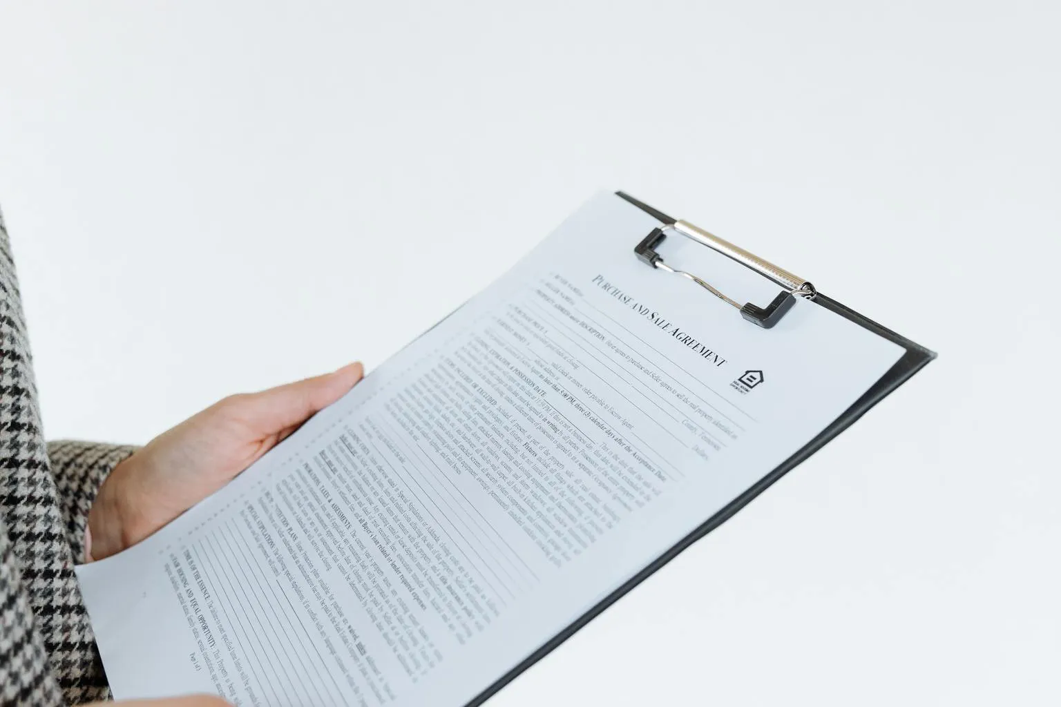 Home warranty contract paperwork with clipboard on professional desk