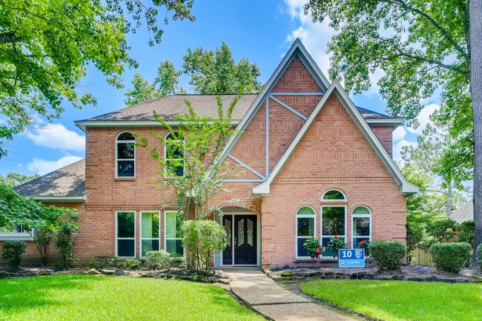 Modern two-story suburban home with brick exterior in Texas residential neighborhood