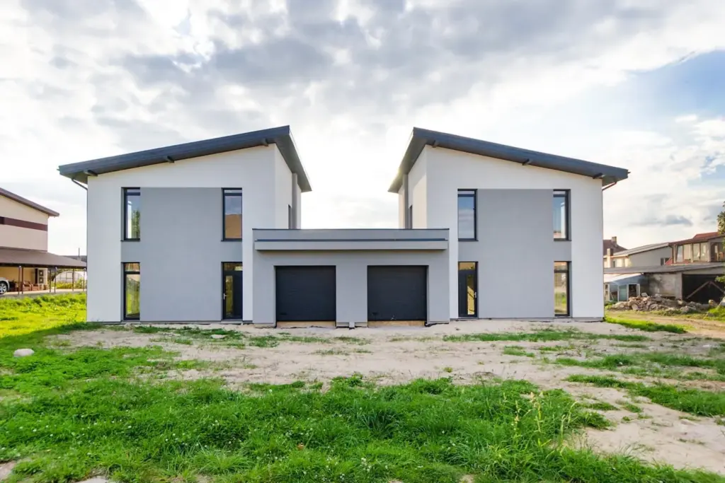 Two matching modern residential homes side by side showing duplex-style living