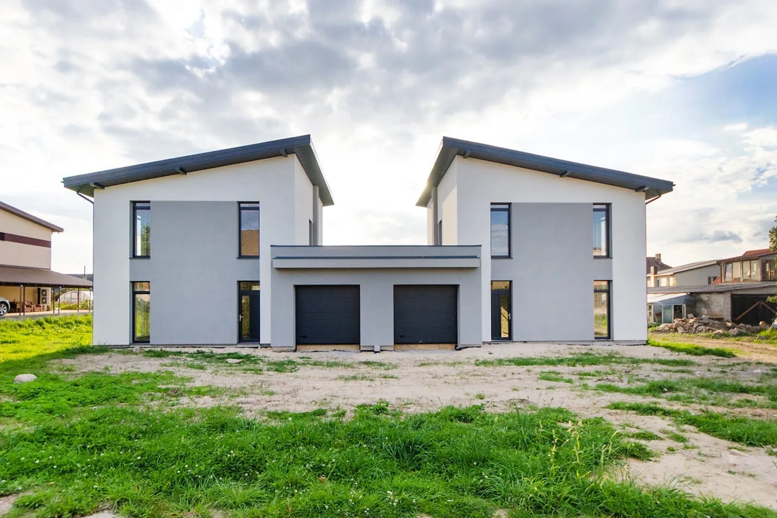 Two matching modern residential homes side by side showing duplex-style living