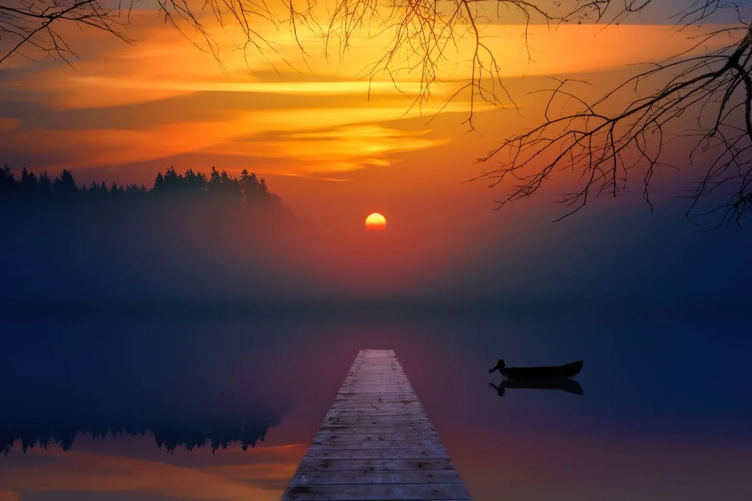 Wooden dock extending over a calm lake at sunset with golden light reflecting on the water