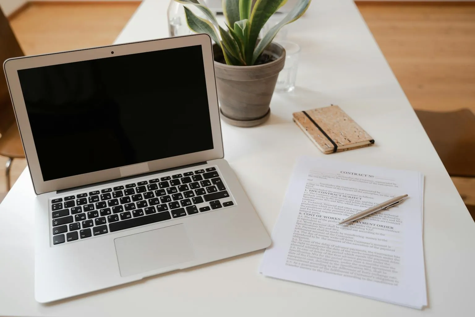 Legal documents and laptop computer on desk for LLC formation