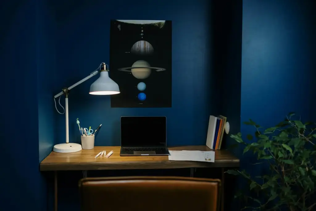 Home office interior with desk, laptop, and natural lighting