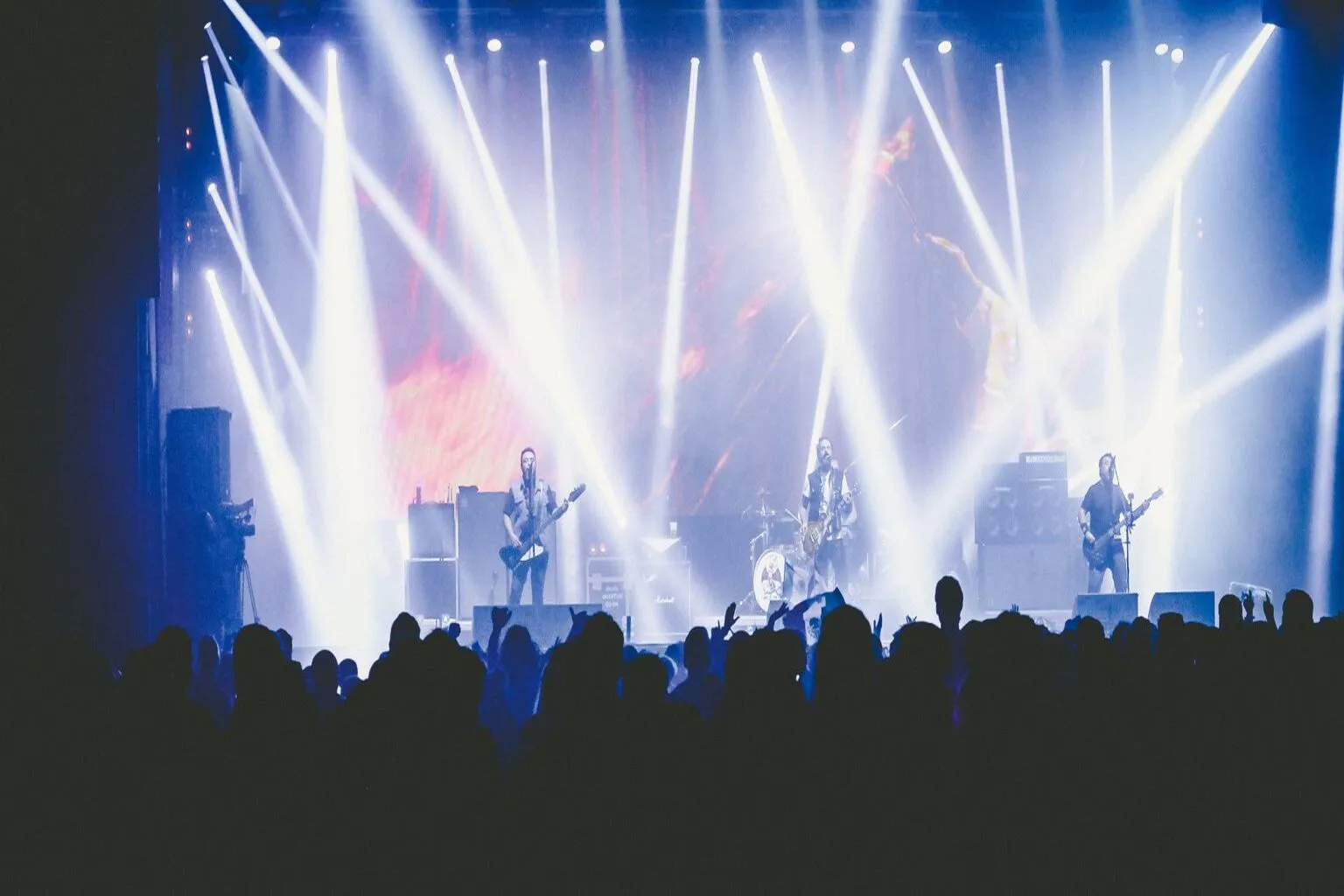 Crowd enjoying live music concert with vibrant stage lighting at Austin music venue