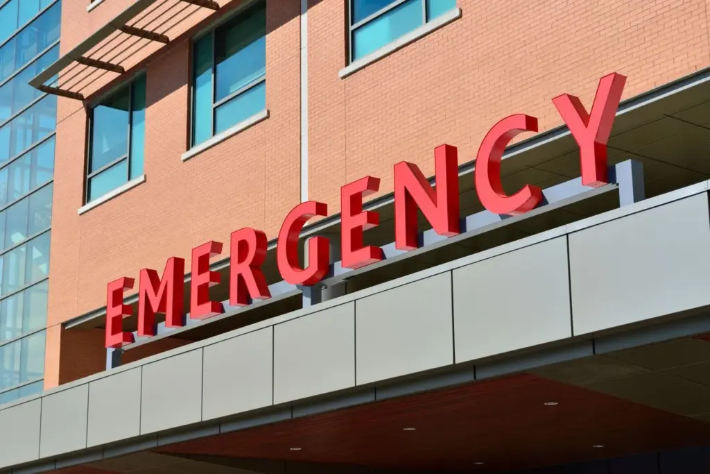 Hospital emergency room entrance with red emergency sign