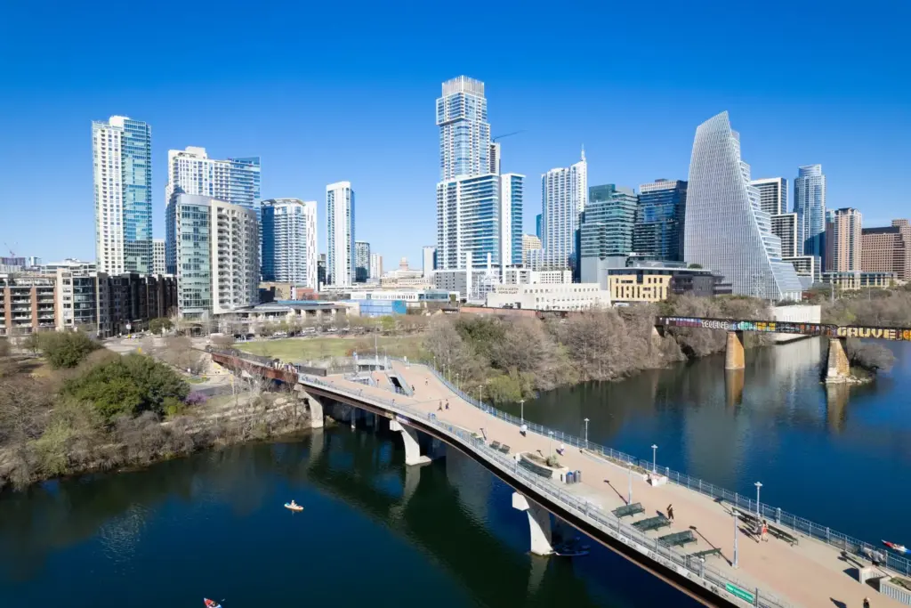 Aerial view of Austin Texas skyline with Congress Avenue Bridge spanning Lady Bird Lake at sunset
