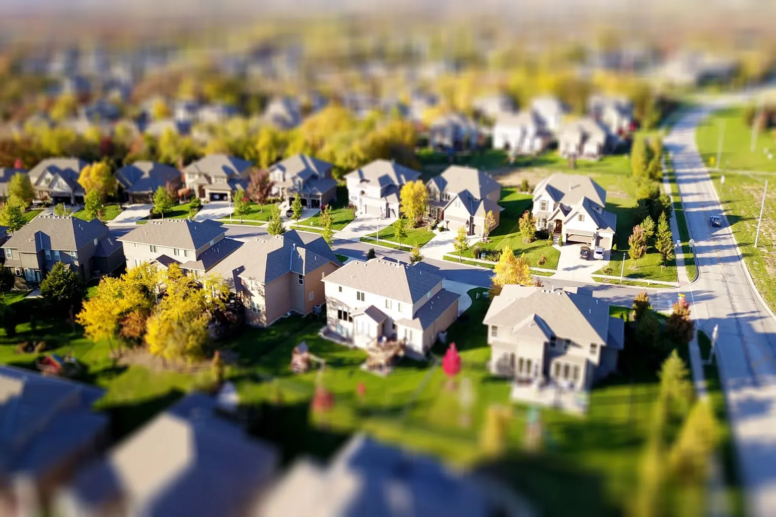 Aerial view of suburban neighborhood with homes and tree-lined streets in the Austin Texas metro area