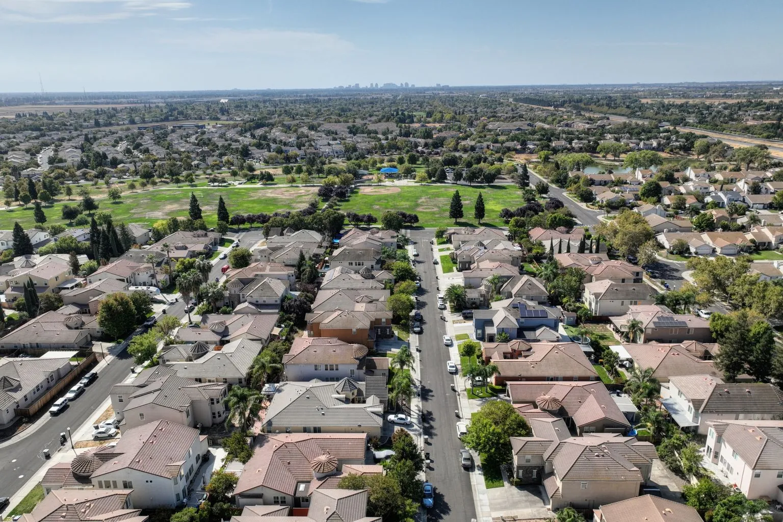 Aerial view of a suburban residential neighborhood with homes and green spaces