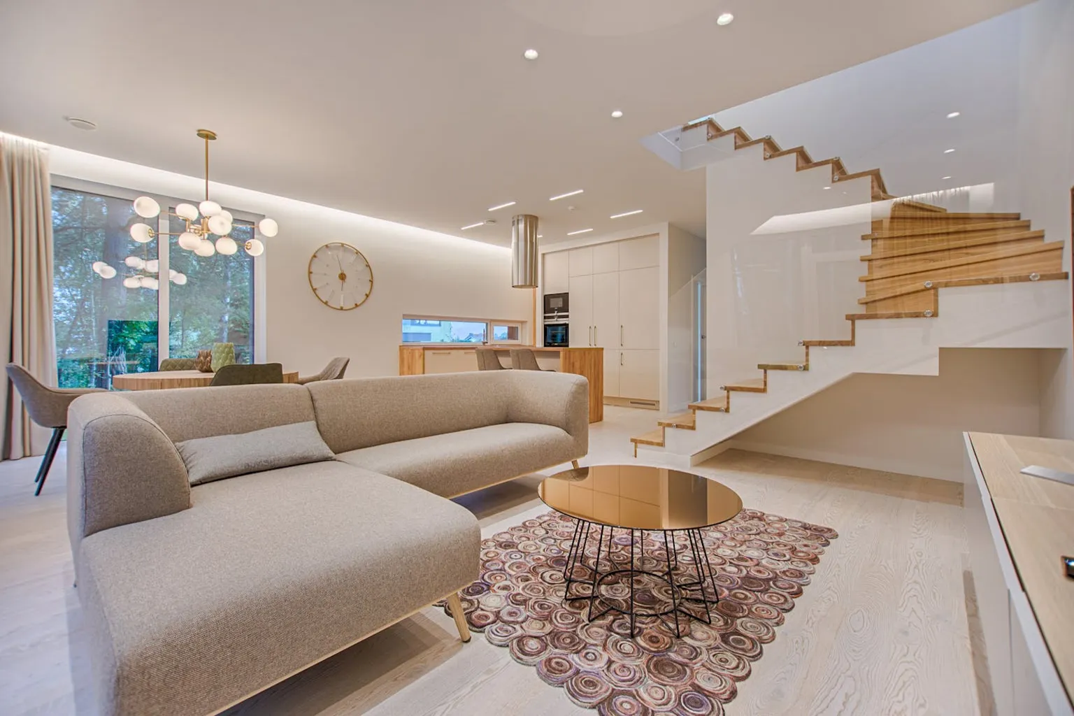 Bright open concept living room with modern furnishings and large windows