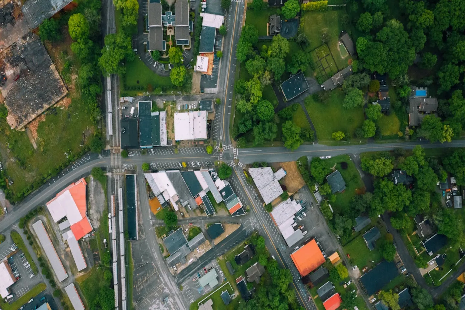 Aerial view of mixed-use neighborhood with homes and commercial buildings