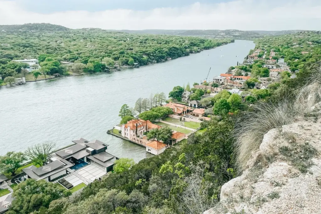 Aerial view of homes on large wooded lots along a Central Texas waterway in the Hill Country
