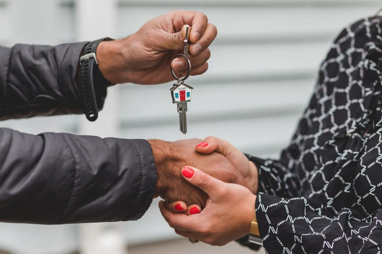 House keys with a home keychain handed over at closing